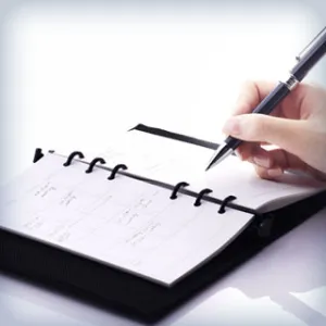 hand holding pen over an agenda